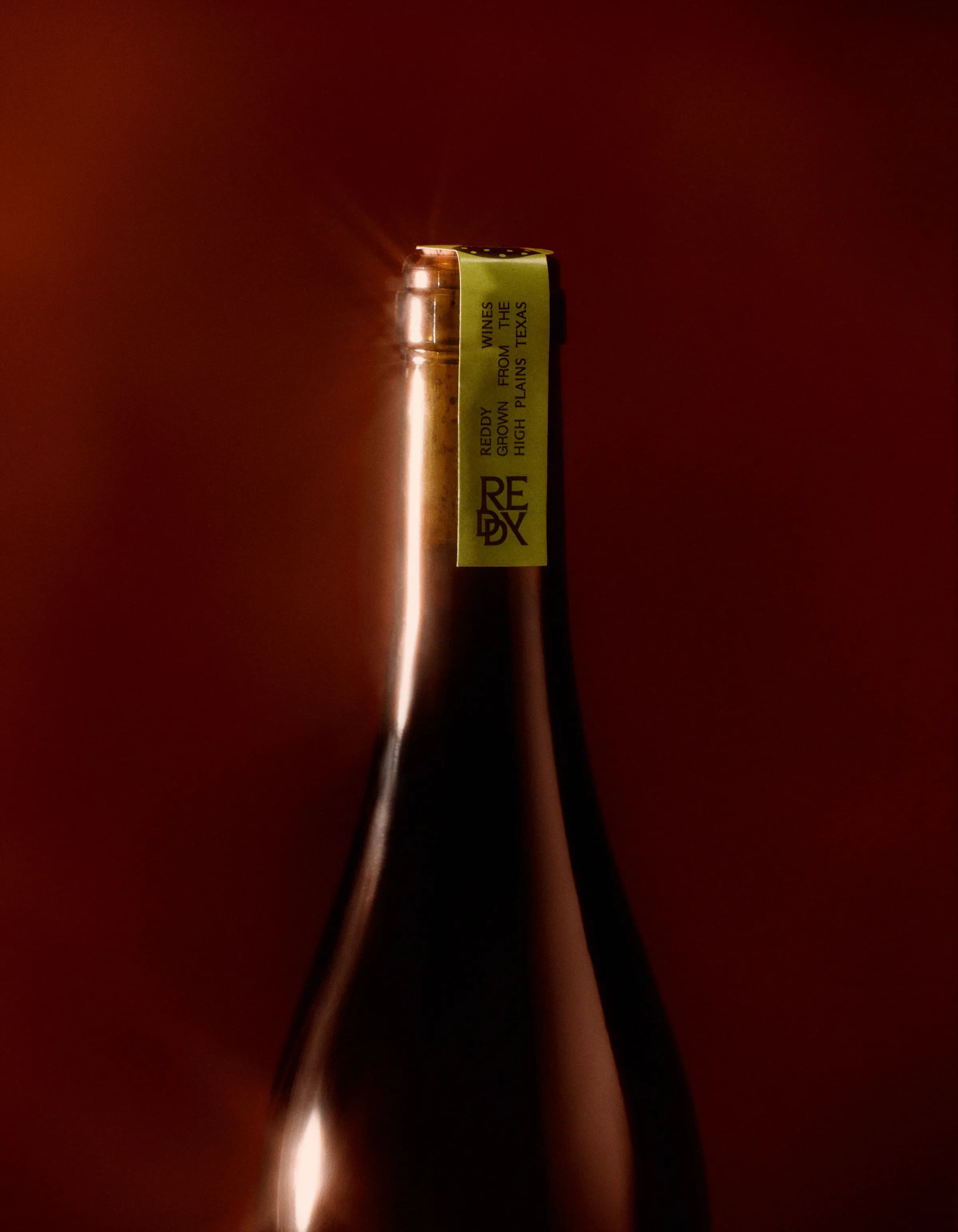 A Reddy Wines bottle neck with its olive label
